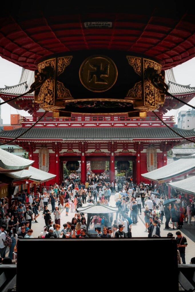 Crowded entrance of Senso-ji Temple in Asakusa, Tokyo, showing its large red gate and many visitors.