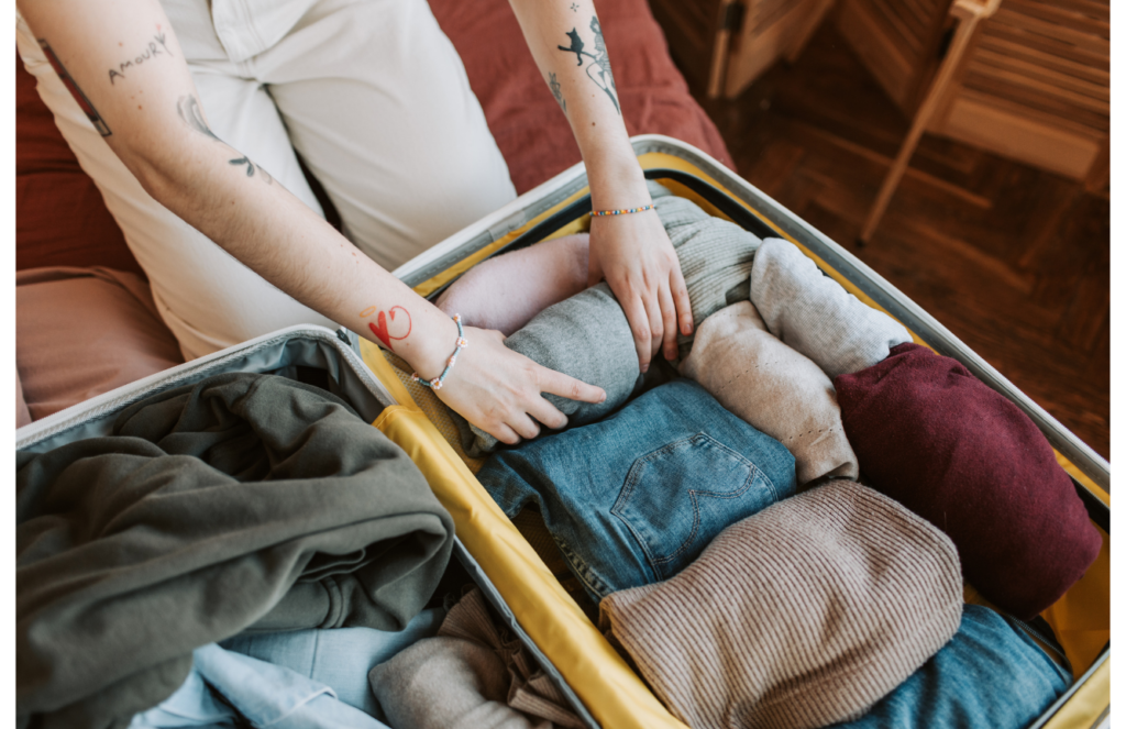 A person packing clothes