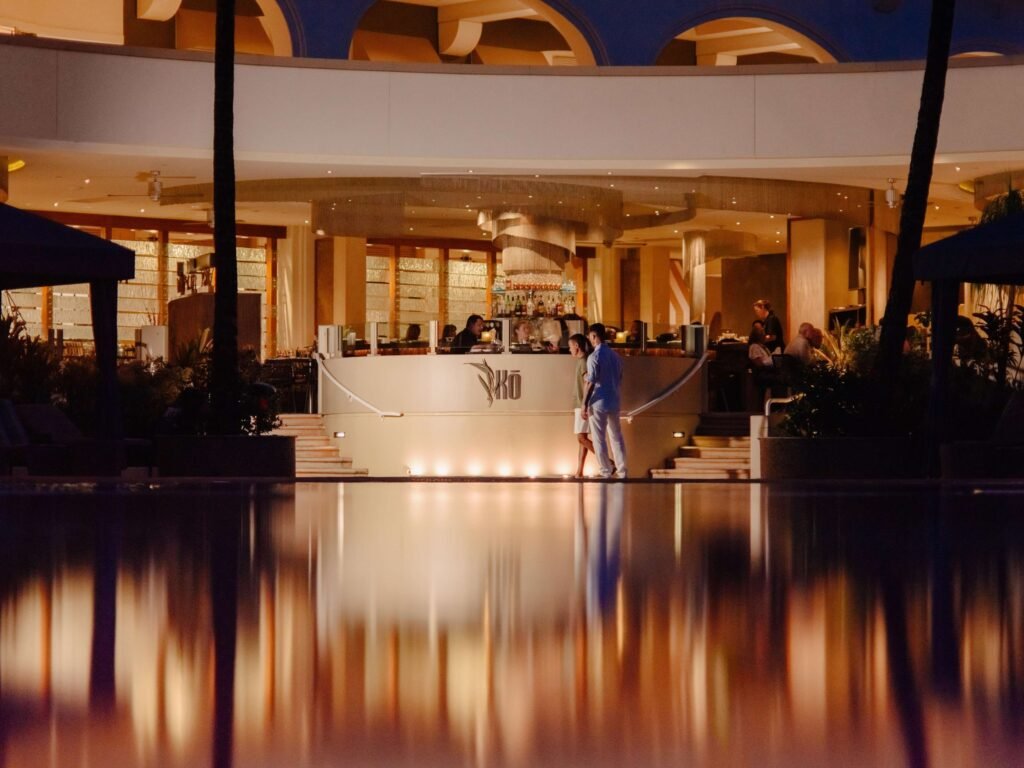 Fairmont Kea Lani-Elegant poolside bar at night with couple walking in front.