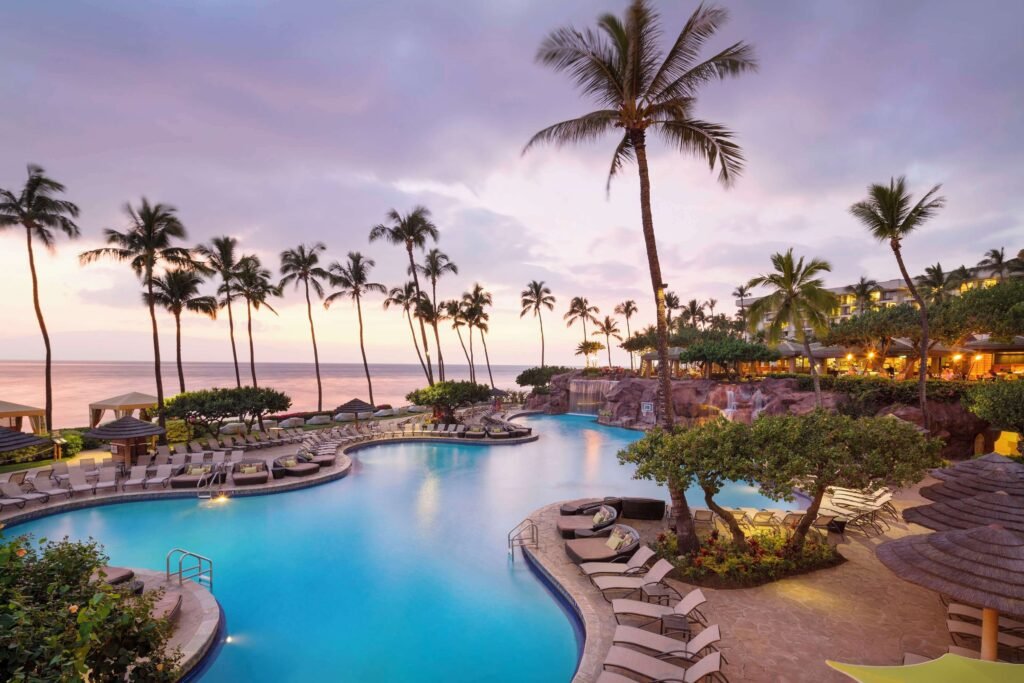 Hyatt Regency Maui Resort & Spa-Scenic resort pool at sunset with palm trees and ocean view