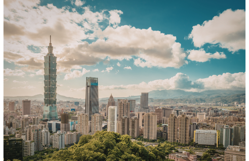 Taipei skyline with taipei 101 tower under a cloudy blue sky